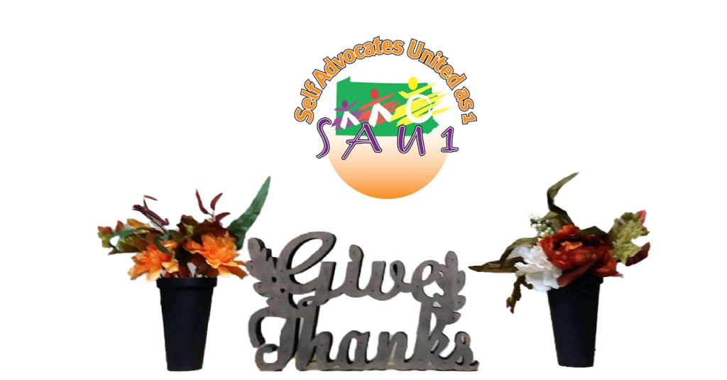 Banner. SAU1 logo above two vases of flowers with the words give thanks between them.